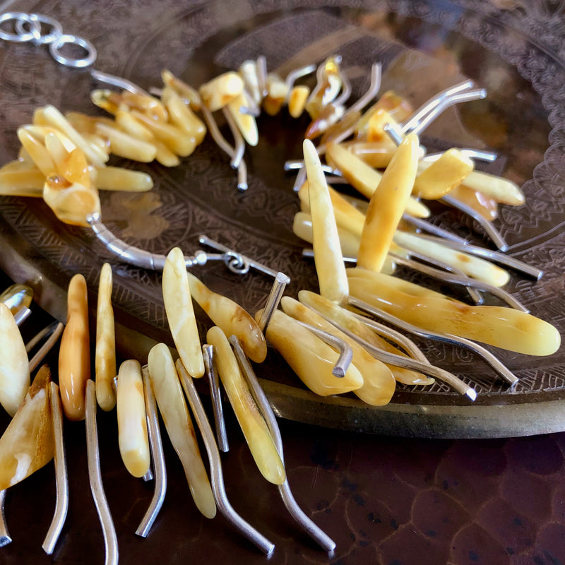 Detail of butterscotch Baltic amber spears and Hill Tribe silver necklace
